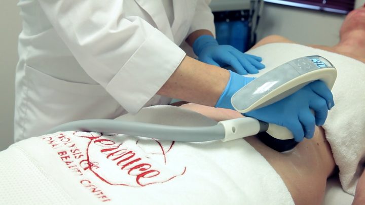 A practitioner at Berenice performing a VelaShape body contouring treatment